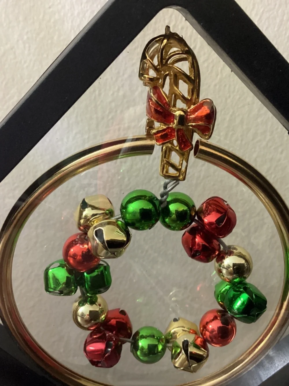Hand crafted Christmas jewelry art red gold green floating jingle bells stand